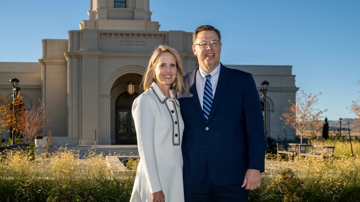 Elder Clark G. Gilbert and his wife, Christine, smiling in front of the Cody Wyoming Temple